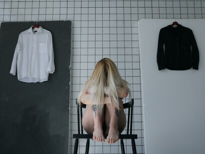 A young woman feeling in despair and conflict with herself and her body, negative attitude