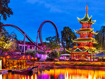 Tivoli Gardens is a famous amusement park and pleasure garden in Copenhagen, Denmark, known for its historic charm and vibrant atmosphere