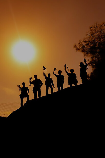 Friends walking on a hill at sunset
