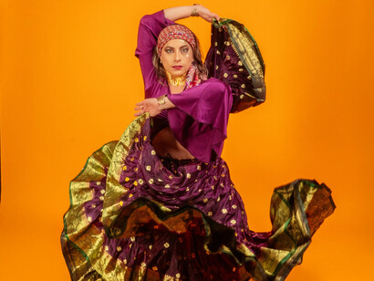 A young woman ruffling a flamenco-style dress
