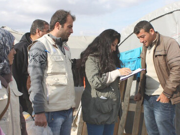 Humanitarian aid is distributed to Syrian refugees at a municipal-run camp in Suruç, southeastern Turke