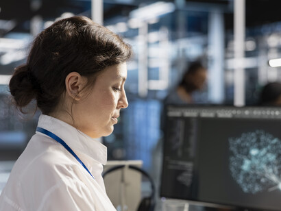 Computer scientist in a data center analysing software logs and performance metrics using AI