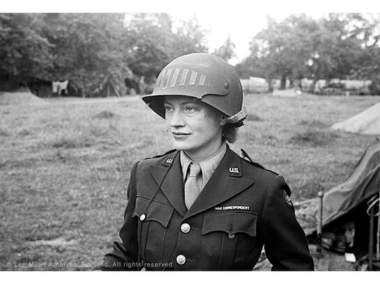 Lee Miller in steel helmet specially designed for using a camera, Normandy, France 1944 by unknown photographer Photographer Unknown © The Penrose Collection, England 2015. All rights reserved