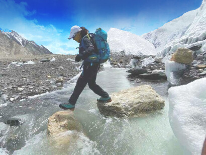 Samina Baig crossed a stream on her way to reach the summit of her next mountain for personal pride and for Pakistan