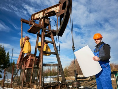 An engineer assessing an oil extraction site, reflecting the role of energy resources in shaping international security