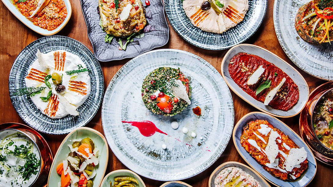 The table is adorned with a stunning display of Turkish appetizers, creating an authentic visual feast that captures the essence of the cuisine