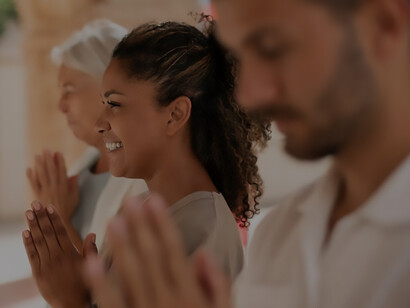 Group of individuals engaged in collective prayer