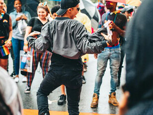 Performer dancing in the rain during a political protest