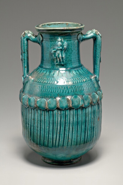 Roman or Parthian, said to be from Emesa (modern Homs), Syria
Glazed Storage Jar (Amphora) with Serapis
2nd–3rd century AD
Glazed terracotta
H. 12 3/16 in. (32.0 cm.), 
Sidney and Lois Eskenazi Museum of Art, Gift of Mrs. Nicholas H. Noyes