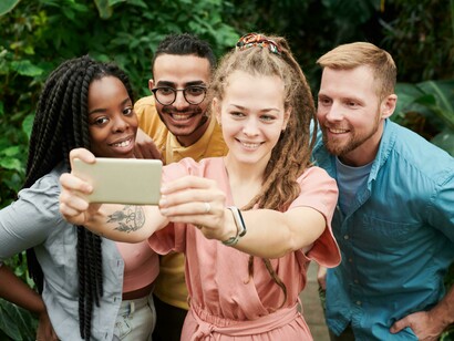 Friends taking a selfie that will later be posted online for likes