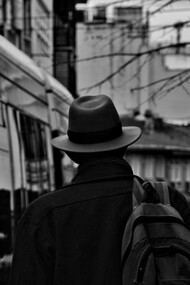 A man wearing a hat and carrying a backpack