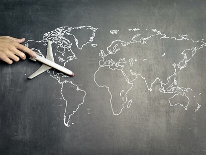 An airplane on a chalk board with a map of the world 