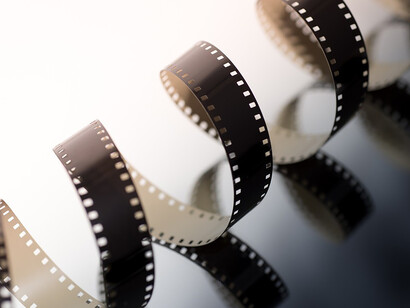 A roll of film on a pristine white surface