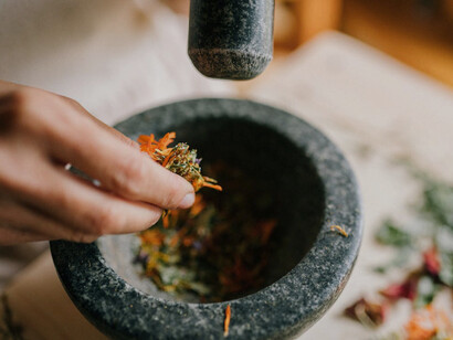 Herbs are ground to release their oils, illustrating simple yet effective wellness methods passed down through generations