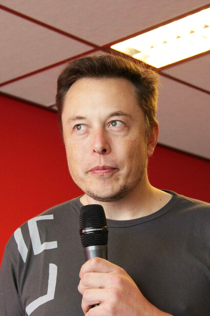 Elon Musk during a press conference; Musk's vision of AI and brain-computer interfaces represents a bold and transformative approach to the future of technology and humanity