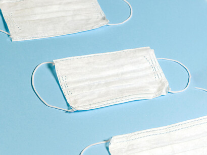 Facemasks on a light blue surface