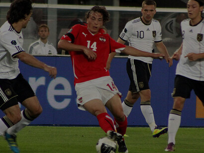 In the UEFA Euro 2012 qualifiers on June 3, 2011, Austria (red) faced Germany (white) at Vienna's Ernst-Happel-Stadion, ending 1:2 (0:1). Pictured: Mats Hummels, Julian Baumgartlinger, Lukas Podolski, and Mesut Özil