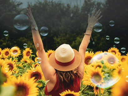 Happy woman in a field of sunflowers