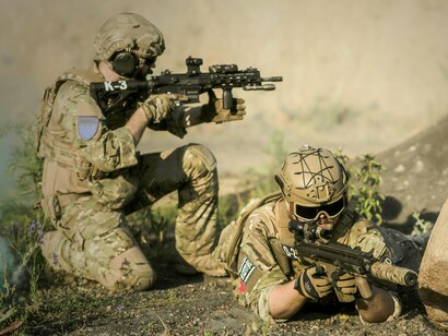 Armed forces observing their surroundings, reflecting the fragile state of international security