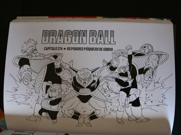 A Dragon Ball manga page displayed across an open book, reflecting the international reach of manga as a cultural export