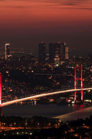 The Bosphorus Bridge comes alive with a mesmerizing glow as night falls over Istanbul