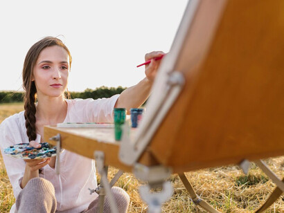 A young woman painting an abstract artwork, exploring colour psychology in her creation