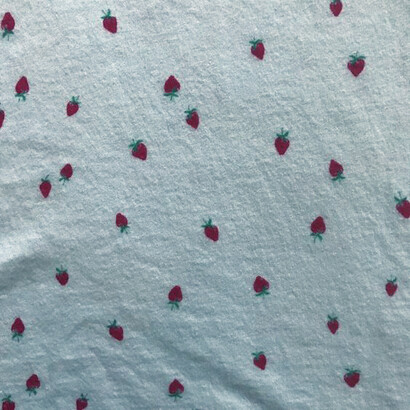 A close up of a strawberry printed pajama tank