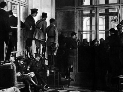 Military officers and politicians climbing over furniture to watch the signing of the Treaty of Versailles in the aftermath of World War 1, June 28th, 1919