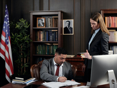 Two lawyers reviewing case documents for an upcoming trial