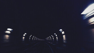 A dimly lit tunel, extending into the darkenss
