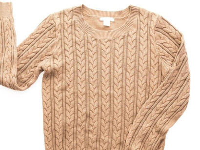 On display, an Irish Aran sweater highlights its timeless design and traditional knitting techniques