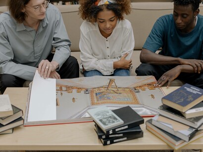 A study group of economics students studying in a library