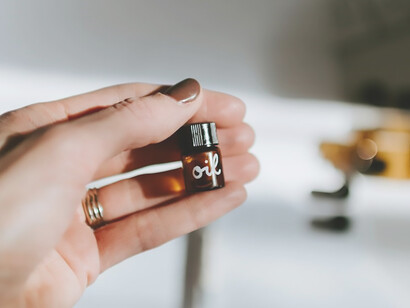 Embarking on a personal journey, a woman is creating her own signature skincare oil