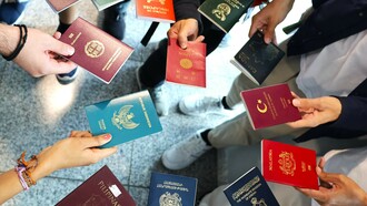 Passports of Wikimania delegates from 11 different countries, reflecting global diversity in mobility and access
