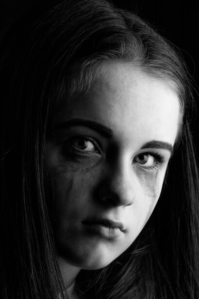 Black-and-white portrait of a crying girl, capturing the raw emotion of depression