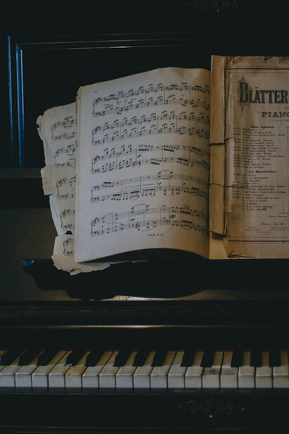 An open book resting atop a beautifully adorned piano, combining the harmony of healing and music