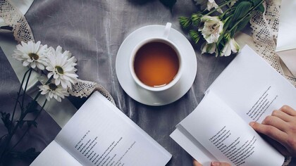 Poems being enjoyed over a couple of tea with the scatterings of nature in its surroundings
