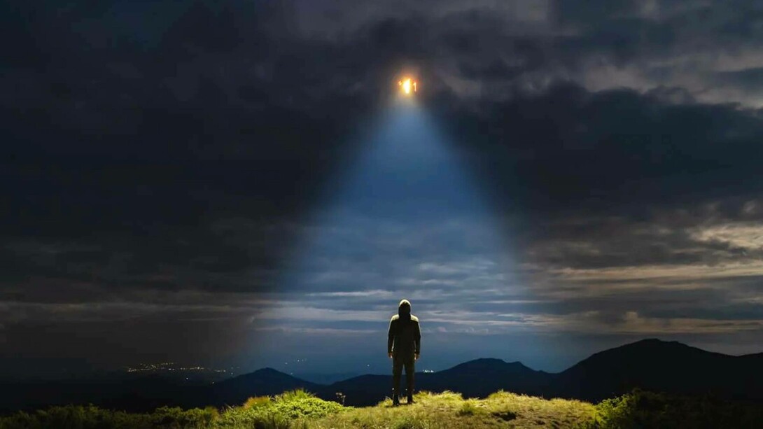 A man looks to the light in the sky