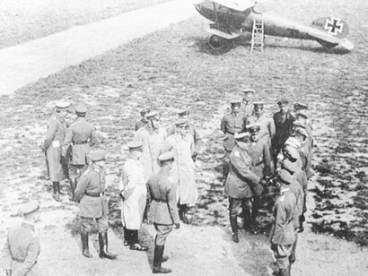Manfred von Richtoffen presenting Meyer (white cap) to Gen. Ludendorf in the summer of 1917, the biplane is one of the overall red Albatros of Manfred