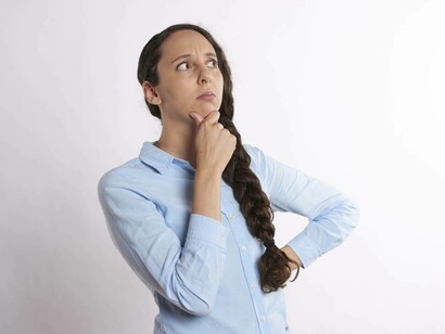 A woman in a blue shirt thinking and questioning her life