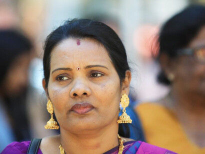A Sri Lankan woman works diligently, showcasing her dedication and commitment to her tasks while striving to achieve her goals