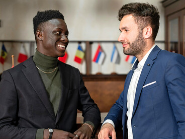 An exchange between international representatives, representing the attempts to rebuild trust between nations