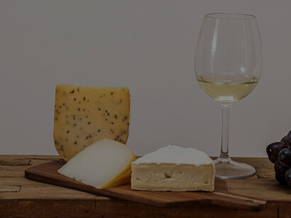 Cheese and Grapes by White Wine in Glass
