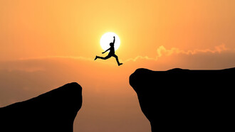 A courageous man leaps through the gap between hills