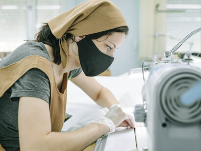 A skilled artisan uses a modern embroidery machine to intricately stitch a Barong Tagalog, preserving centuries of Filipino tradition with contemporary precision