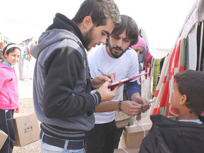 Syrian refugees receiving humanitarian aid at a municipal-run refugee camp in Suruç, southeastern Turkey