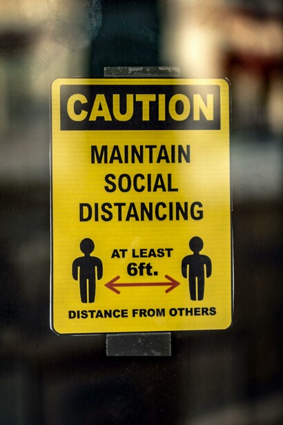 A sign that reads: Caution, maintain social distancing. As a reminder of the protocols to follow during the Pandemic of Covid-19