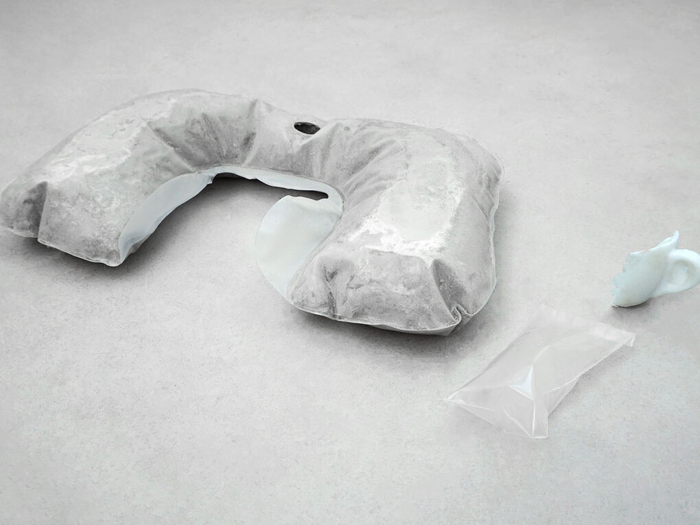 Rowena Harris, The fundamental ergonomics of body meets machine, 2015, neck cushion inflated with concrete, cast silicon rubber, sealed plastic containing one breath, 56 x 30 x 9 cm