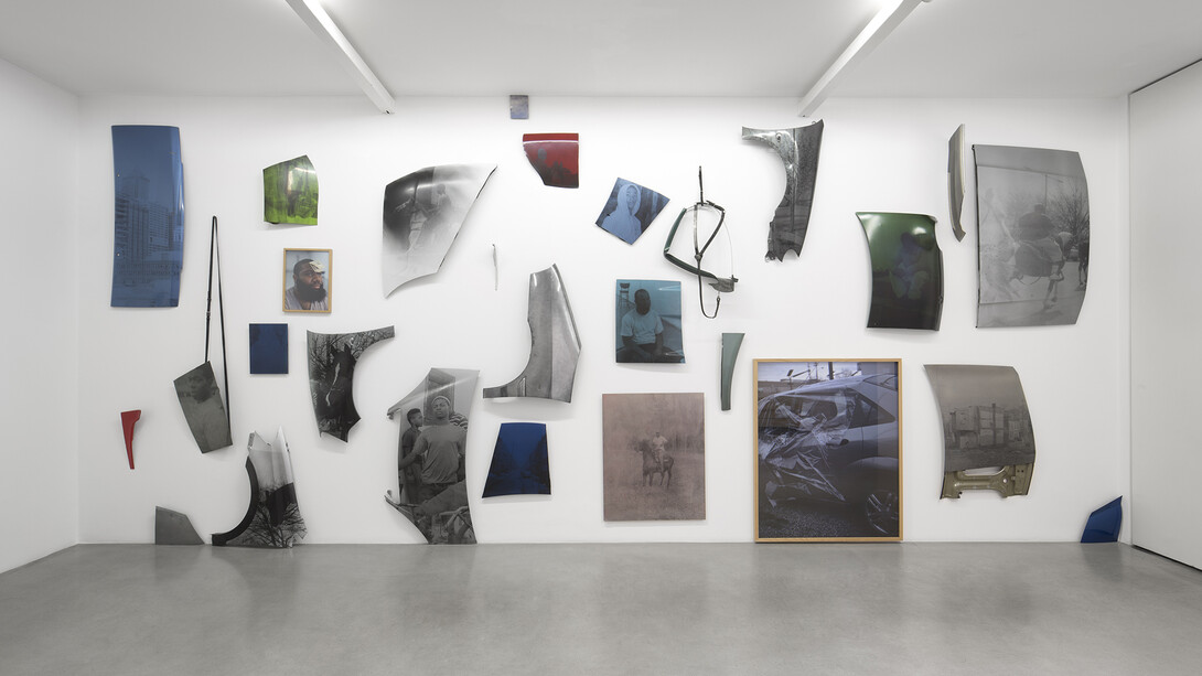 Mohamed Bourouissa, I'm Smilling And I'm Acting Nothing Wrong, 2015, 29 Tirages argentiques sur capot de voiture / 29 silver prints on car hoods, Dimensions variables / Variable dimensions, Vue de l’exposition / View of the exhibition « Hustling », kamel mennour, Paris, 2015 © Mohamed Bourouissa. Photo: Julie Joubert, Courtesy the artist and kamel mennour, Paris