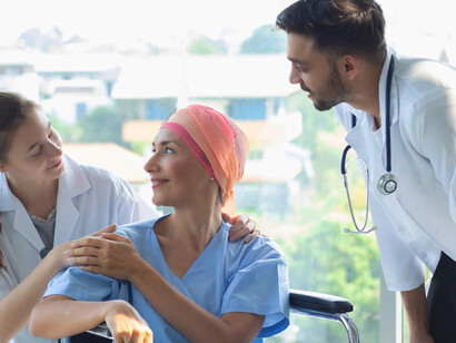 During the treatment, a caring nurse and a male doctor work together to offer comfort and support to a cancer patient